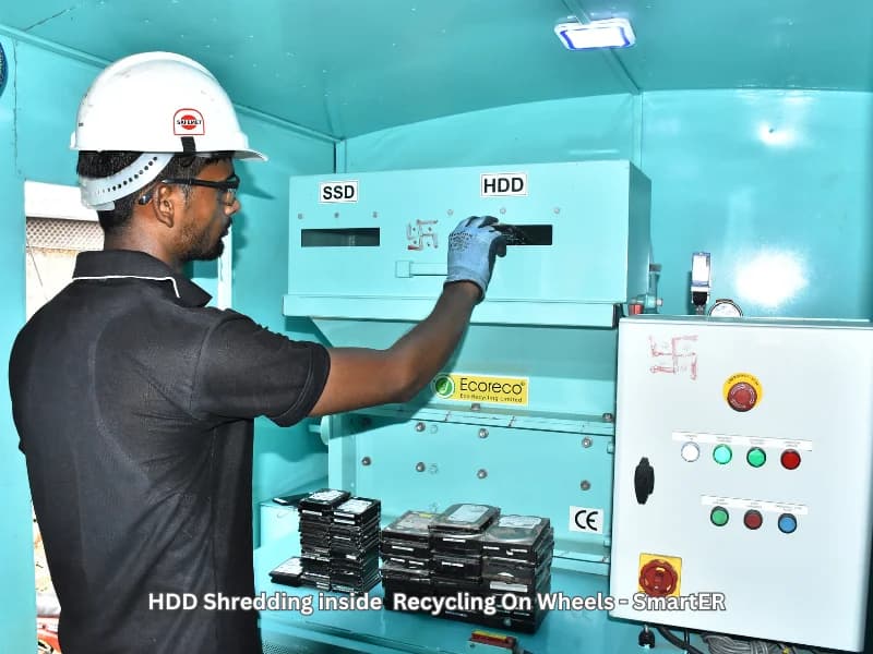 An Ecoreco operator shredding hard drives inside the Recycling on Wheels unit